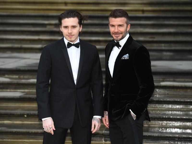 Brooklyn Beckham (l) mit seinem Vater David Beckham, ehemaliger Fußballspieler der englischen Nationalmannschaft. Foto: Kirsty O'connor/PA Wire/dpa