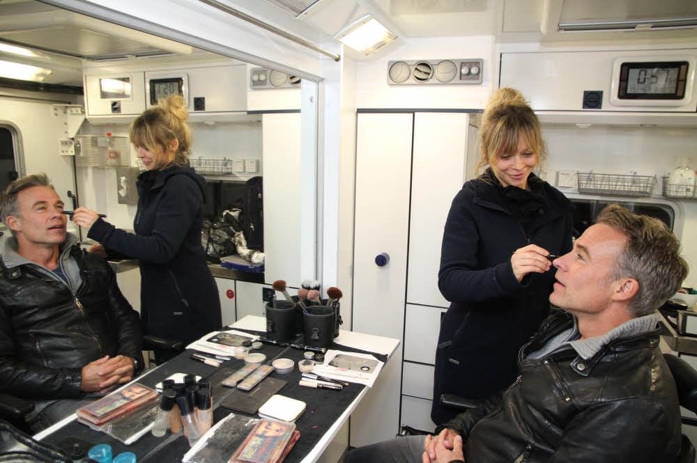 In der Maske: Schauspieler Marco Girnth (rechts) wird von Maskenbildnerin Antje Neumann für den Dreh vorbereitet.