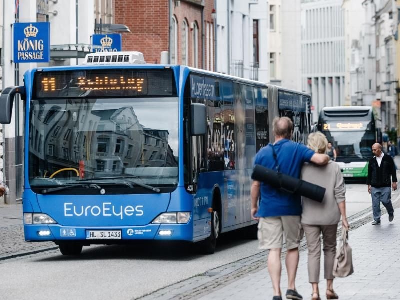 Busse fahren durch das Lübecker Stadtzentrum. Foto: picture alliance / dpa/Archivbild