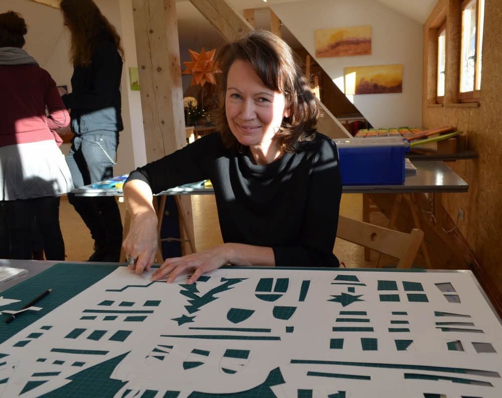 Die Künstlerin Heike Wolff bastelt Fensterbilder aus Papier in ihrem Atelier, das Besuchern offen stand.