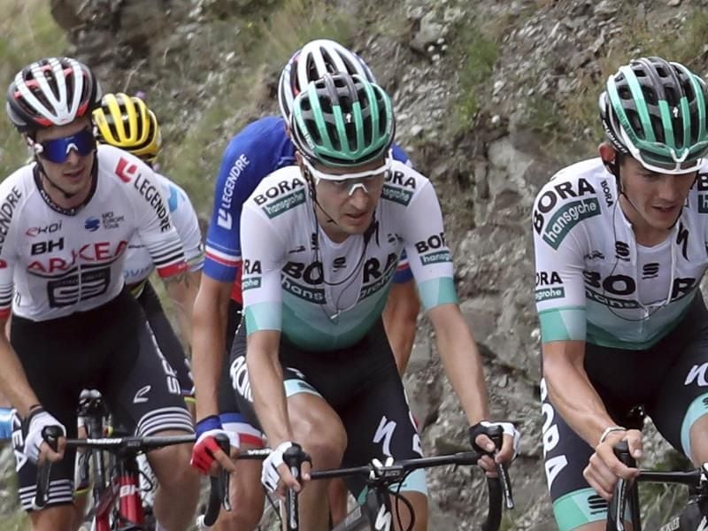 Hat seine Teamkameraden mit einer fehlerlosen Tour-Leistung beeindruckt: Emanuel Buchmann (M) vom Team Bora-hansgrohe. Foto: Thibault Camus/AP