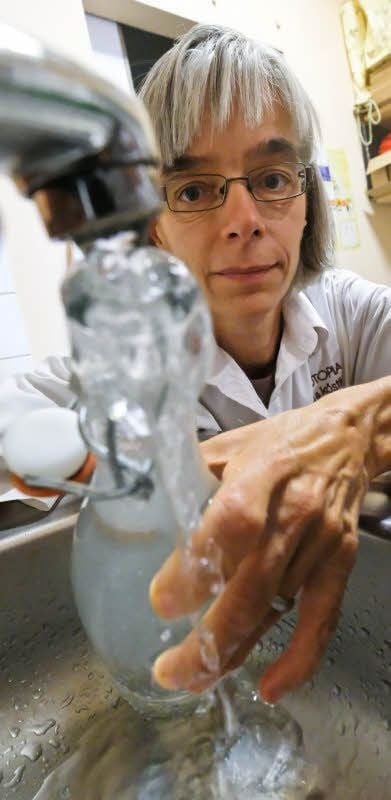 Birgit Rufer füllt in ihrem Geschäft eine Wasserflasche auf.