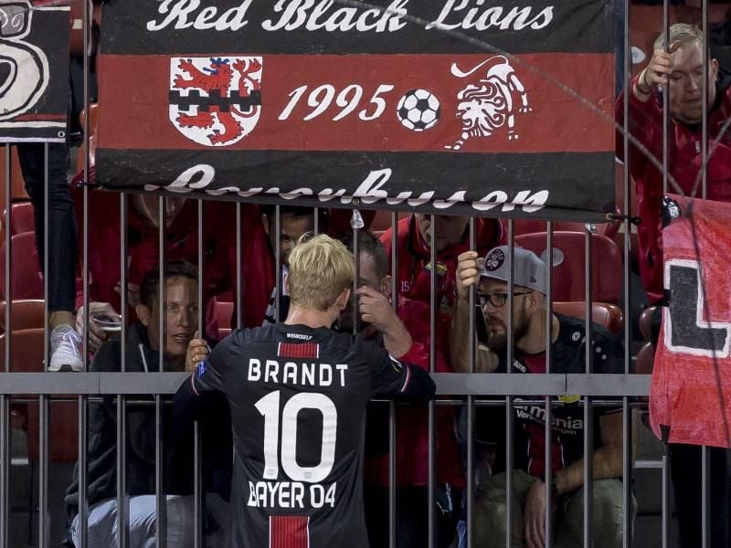 Julian Brandt ist nach Spielende zu den mitgereisten Leverkusener Fans gegangen und spricht mit ihnen. Foto: Patrick B. Kraemer/KEYSTONE