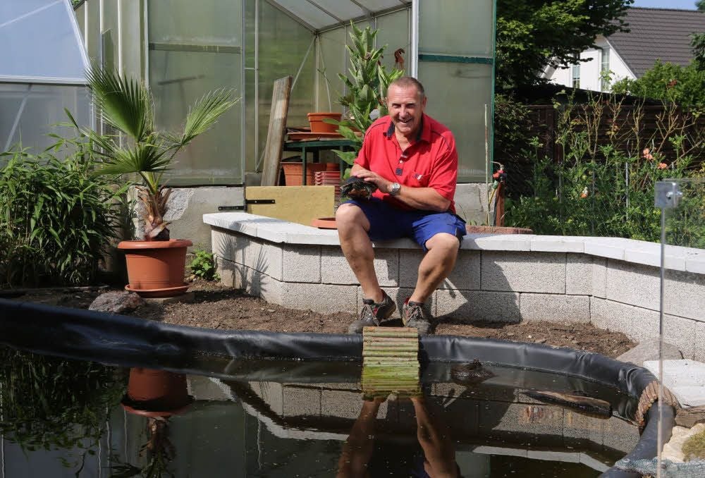 Rolf Schumann sitzt an der neuen Anlage, in der jetzt bis zu 30 Wasserschildkröten Platz finden.