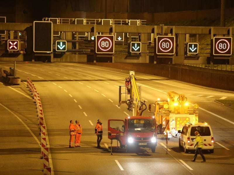 Mitarbeiter stehen vor dem Elbtunnel auf der Autobahn 7. Foto: Bodo Marks/dpa/Archivbild