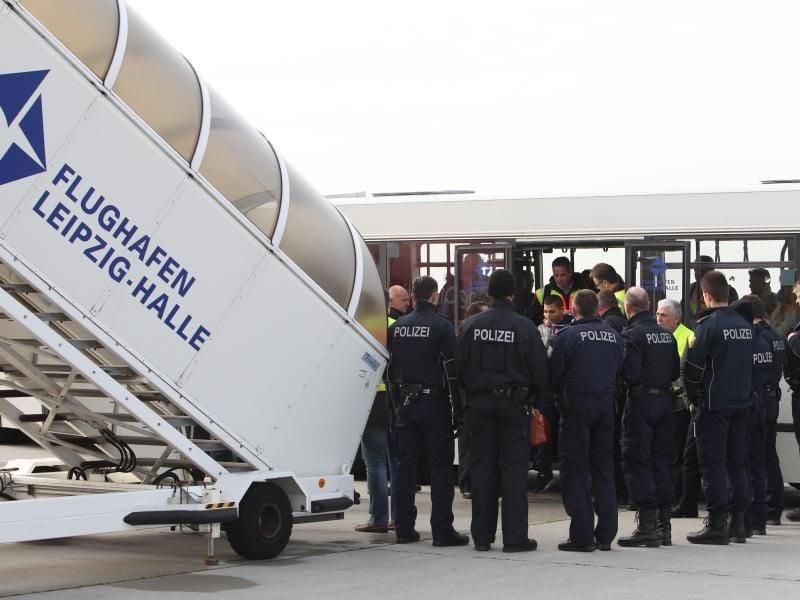 Polizisten überwachen eine Abschiebung auf dem Flughafen Leipzig-Halle. Foto: Sebastian Willnow