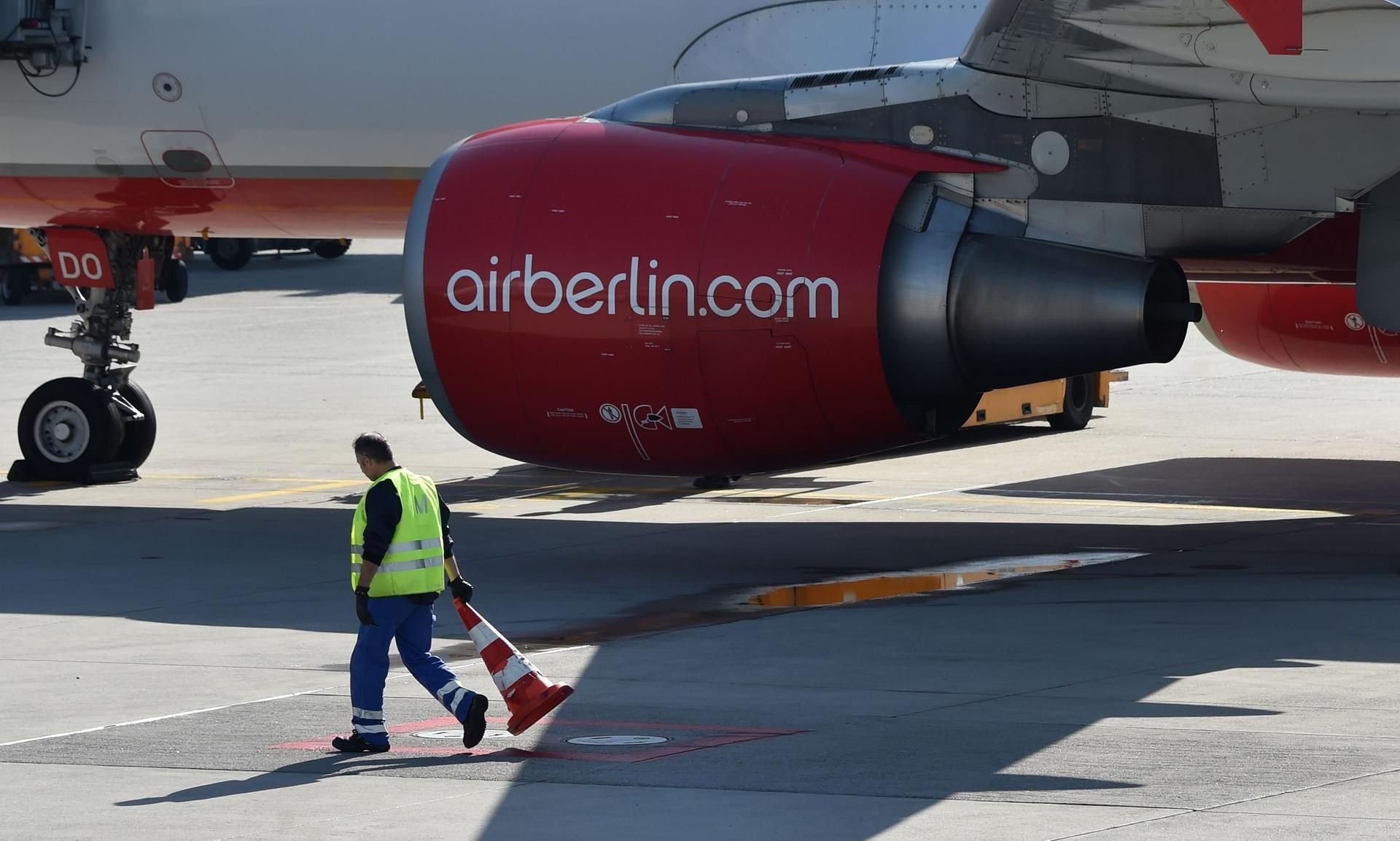 Ein Mitarbeiter räumt das Feld vor einer Air-Berlin-Maschine.