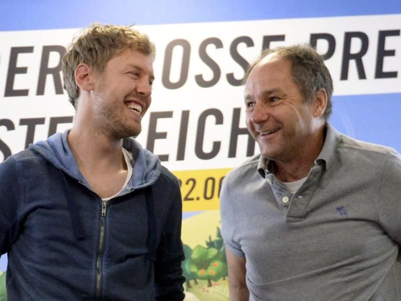 Sebastian Vettel (l) im Gespräch mit Gerhard Berger. Foto: Hans Klaus Techt/APA/dpa