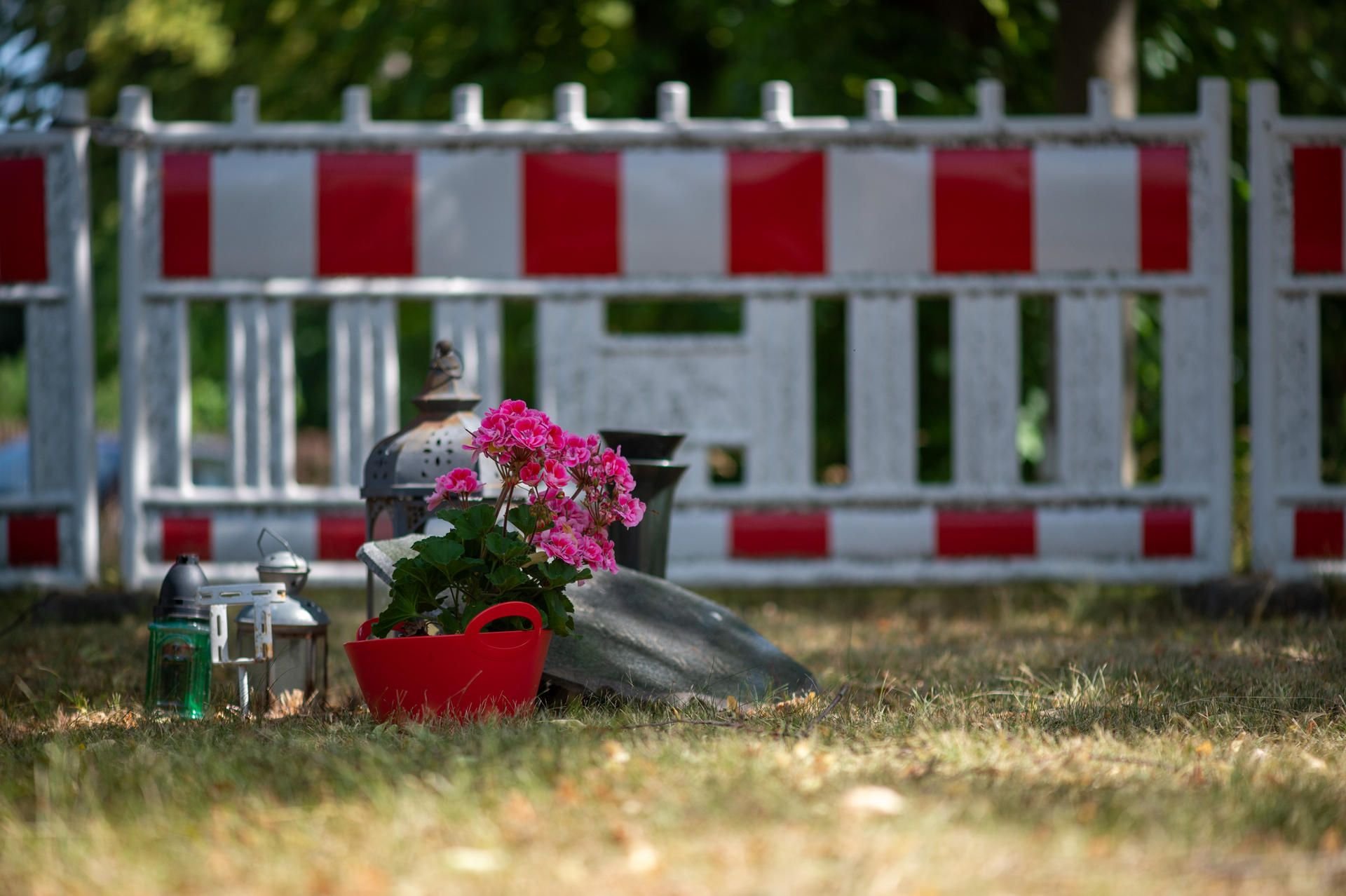 Blumen an einem Gedenkstein vor dem Absperrzaun erinnern an drei Menschen, die beim Erdrutsch von Nachterstedt ums Leben kamen. Seit dem Unglück war der Concordiasee für jede touristische Nutzung gesperrt.