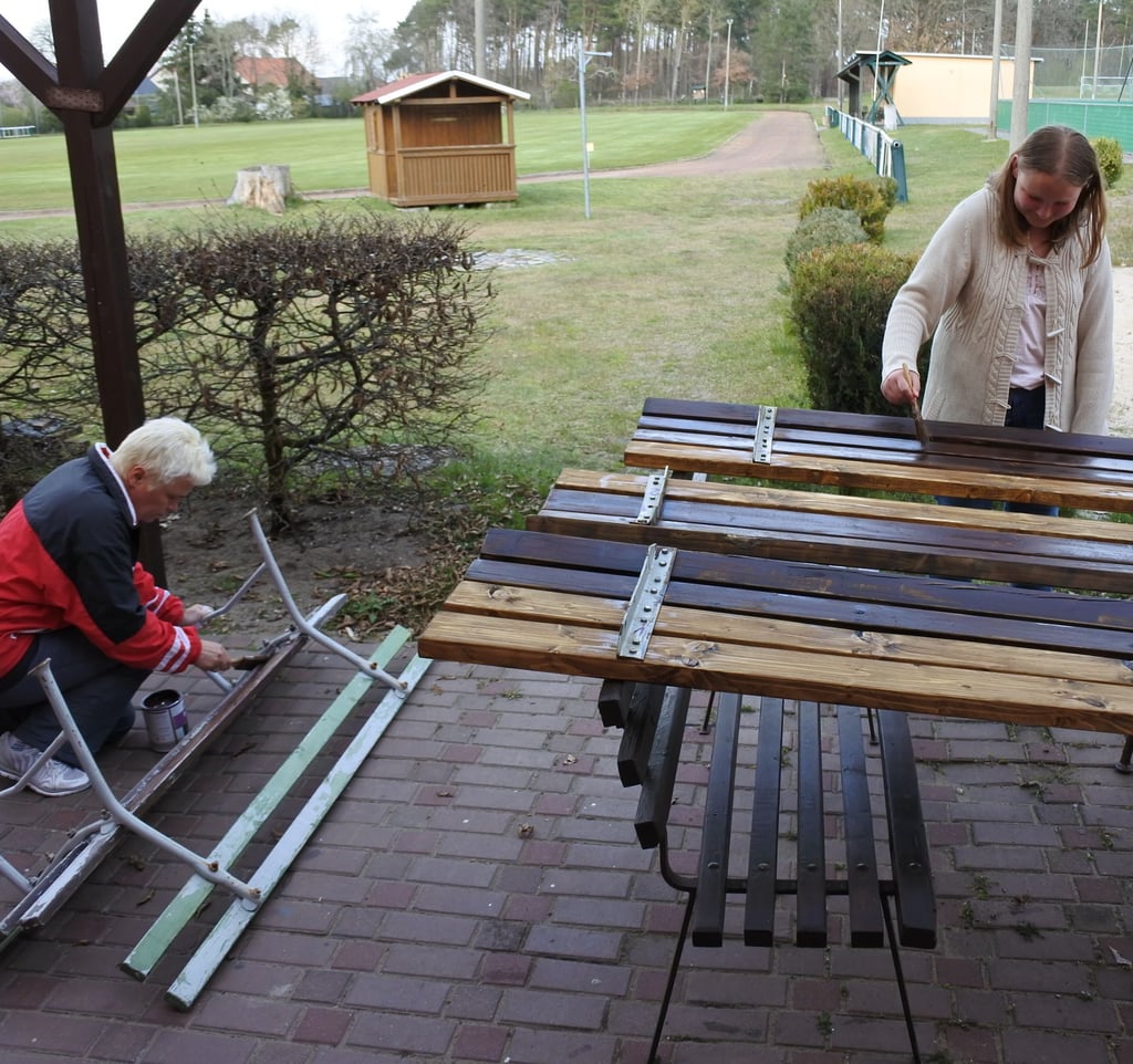 Auf der Klubterrasse wurden tags zuvor die ersten Bänke gestrichen – hier von Johanna und Klubbetreuerin Uta Freihorst .