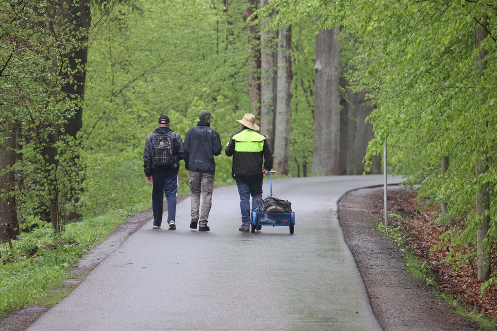 Spaziergänger laufen auf einem Weg im Thüringer Mühltal. Bei regnerischem Wetter und unter Coronabedingungen waren nur wenige Feiertagsausflügler an Christi Himmelfahrt unterwegs.