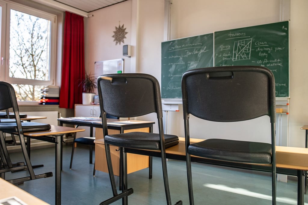 Hochgestellte Stühle in einem leeren Klassenzimmer einer Gesamtschule.