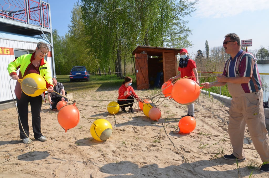 Die Genthiner DLRG-Mitglieder bereiteten am Sonnabend den Zabakucker Kiessee für die Saison vor. Hier richten sie die Abgrenzung für die Nichtschwimmer-Bereich vor, die später aufgespannt wurde.