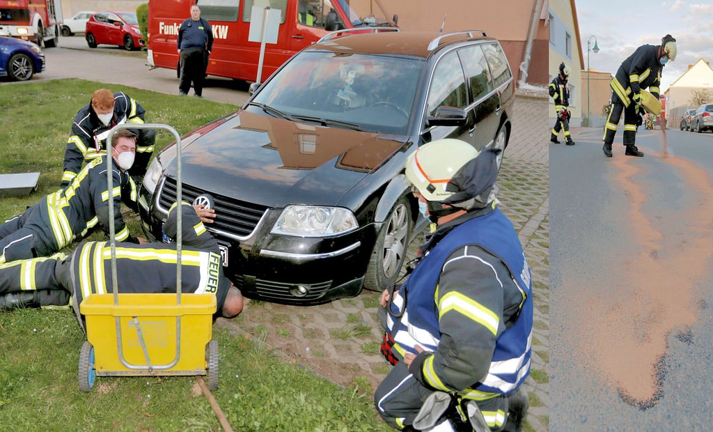 Kameraden der freiwilligen Feuerwehr untersuchen ein Fahrzeug in Hecklingen. Öl tritt aus. Die Spur zieht sich durch den Ort und wird beseitigt.