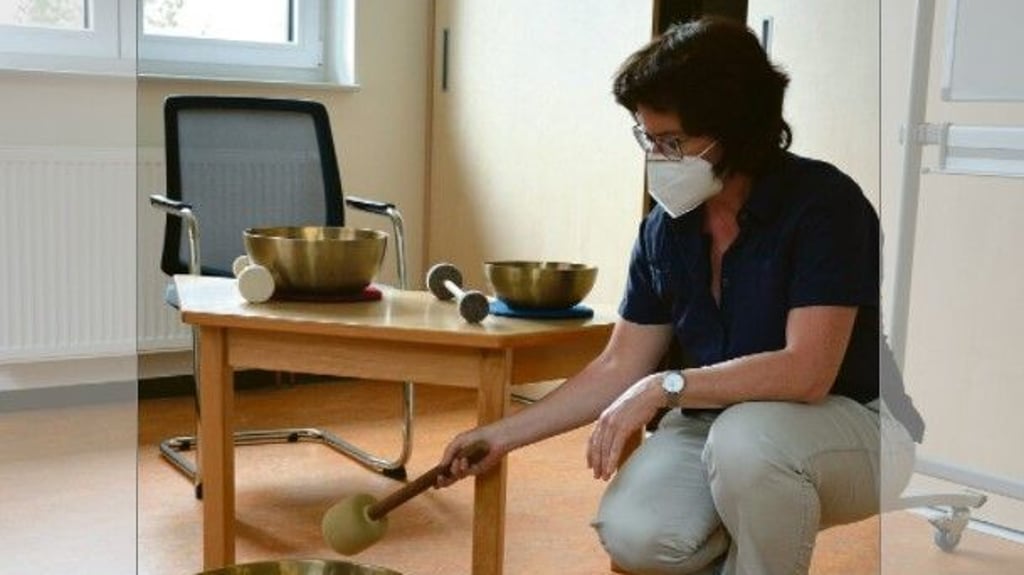 Astrid Braun, Leiterin des Cochlea-Implant-Rehazentrums Sachsen-Anhalt, an der großen Klangschale, die Therapeuten des Zentrums für Entspannungsübungen einsetzen.