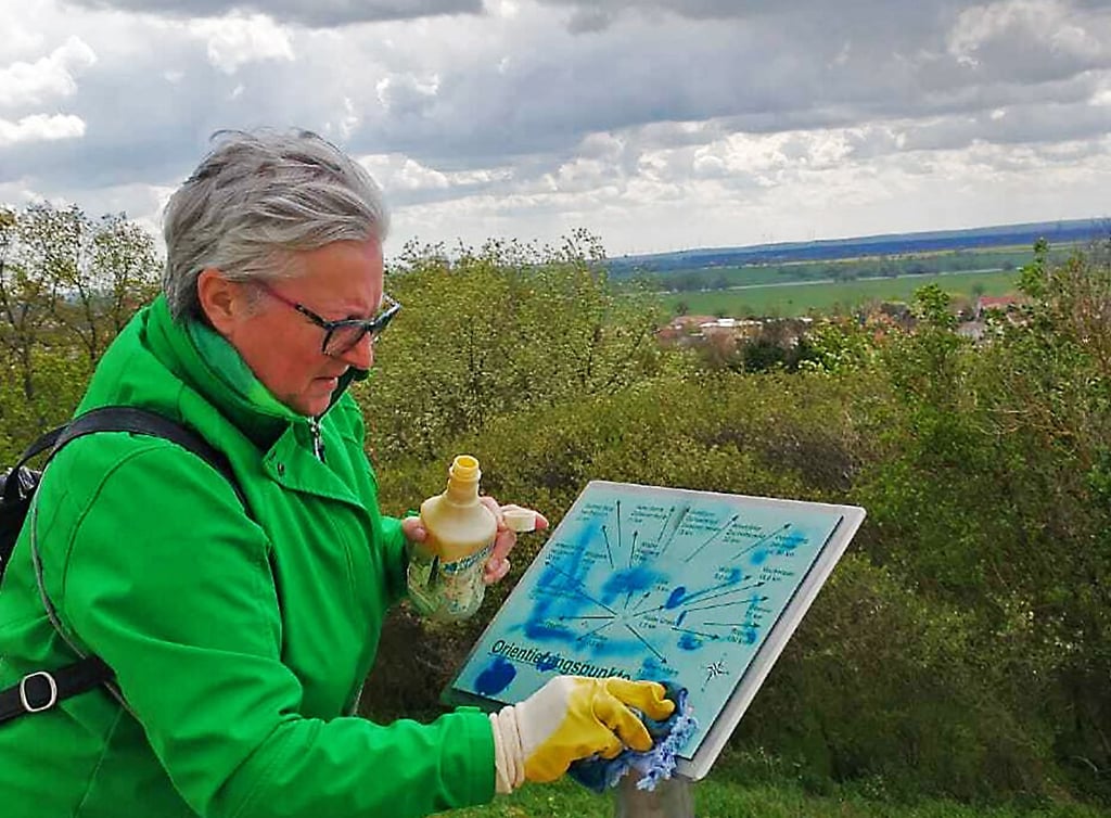 Angela Menzel beseitigt Schmierereien am Apollensberg.