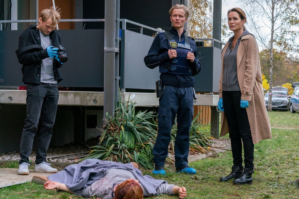 Linus (Anton Spieker, l), Streifenpolizist Kimmich (Roman Schomburg, 2.v.r.) und Maike (Anja Kling) am Tatort.