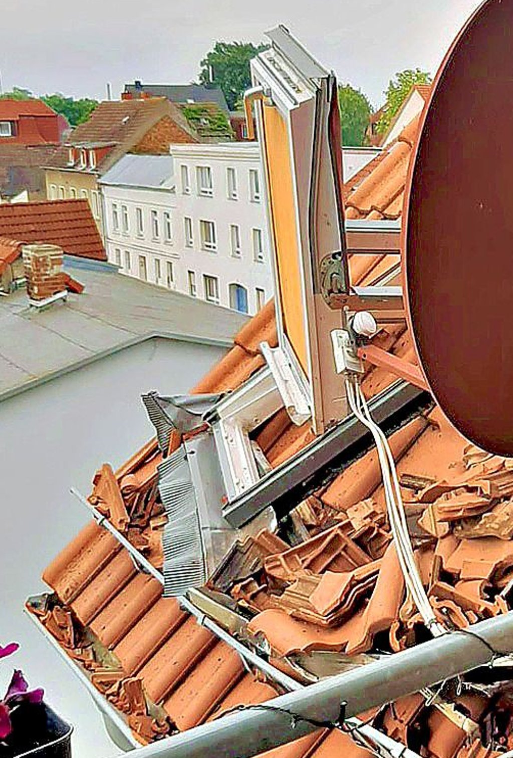 Etliche Ziegel sind abgelöst, ein Dachfenster ist kaputt.