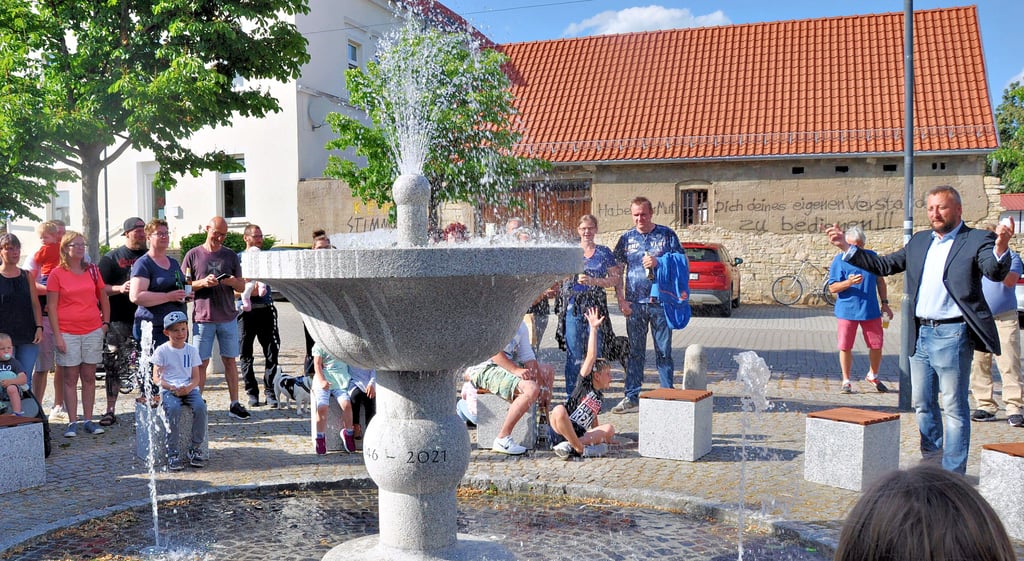 Im Beisein von zahlreichen Bürgern der Gemeinde weihte Bürgermeister Sven Rosomkiewicz (rechts) am späten Samstagnachmittag, 12. Juni 2021, auf dem Dorfplatz in Borne den neuen Brunnen der Gemeinde feierlich ein.