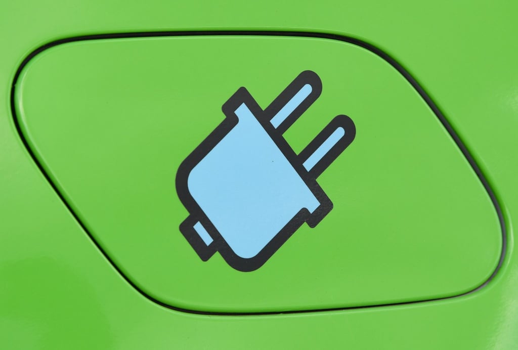 Ein Stromstecker-Symbol auf der Tankklappe eines Elektrofahrzeuges.