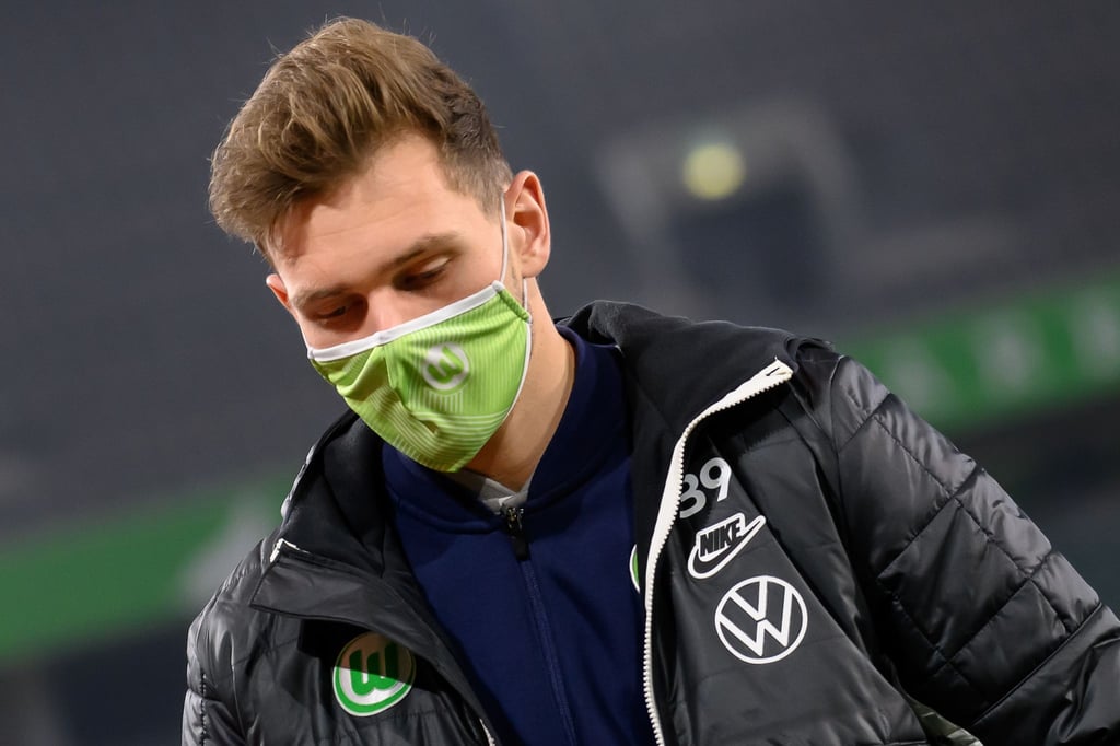 Wolfsburgs Tim Siersleben trägt vor dem Spiel Mund-Nasen-Bedeckung.