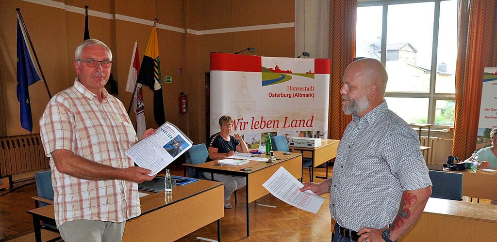 Lars Henning (rechts) übergab während der Ratssitzung im Osterburger Verwaltungsgebäude eine Liste mit 373 Unterschriften gegen das Wohngebiet an den Stadtratsvorsitzenden Torsten Werner.