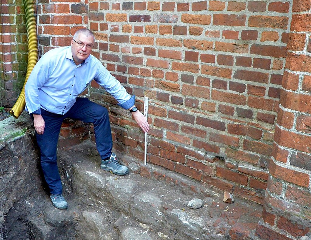 Der leitende Architekt Jens Burkhard zeigt, an welchen Stellen die Feuchtigkeit ins Mauerwerk des Doms eindringt.