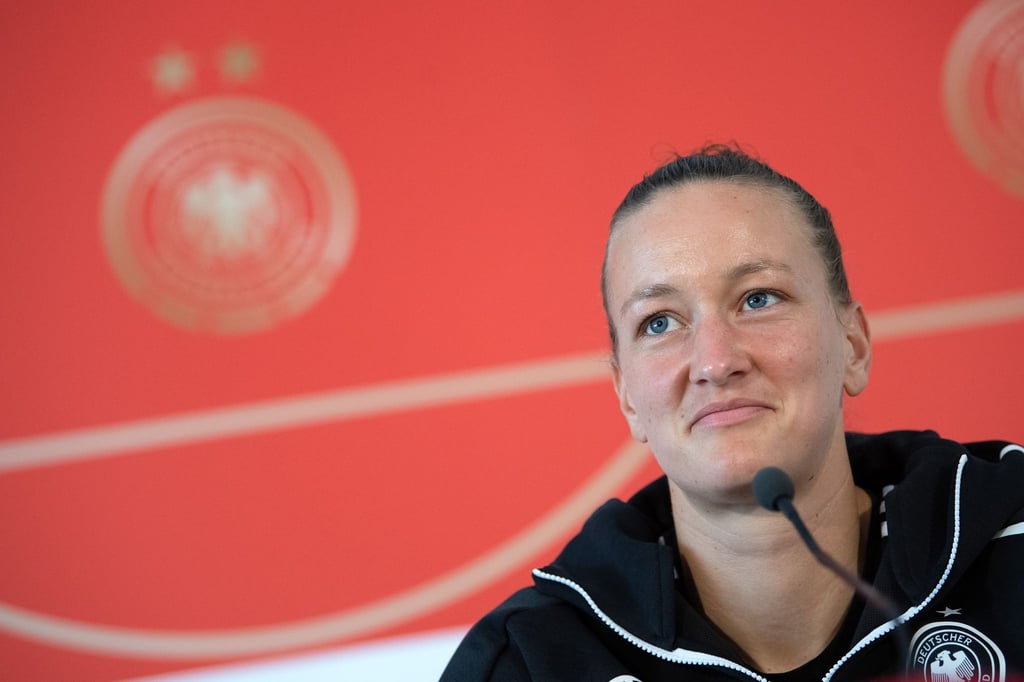 Torhüterin Almuth Schult sitzt während einer Pressekonferenz auf dem Podium.