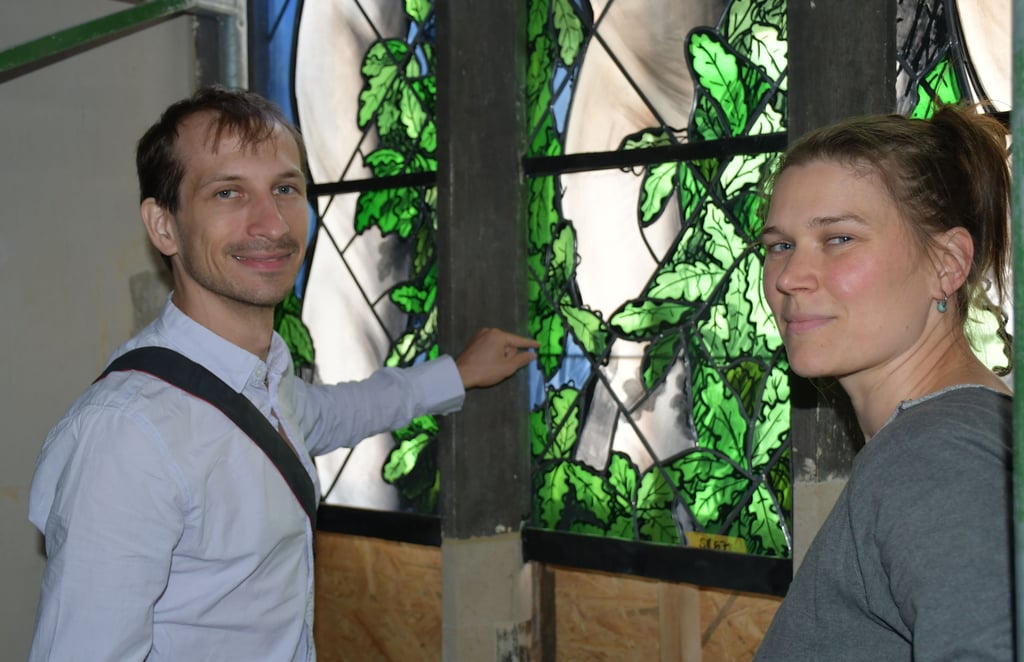 Julian Plodek und Kollegin Inka Schubert überprüfen vor den neuen Kirchenfenstern, ob farblich noch nachgearbeitet werden muss.