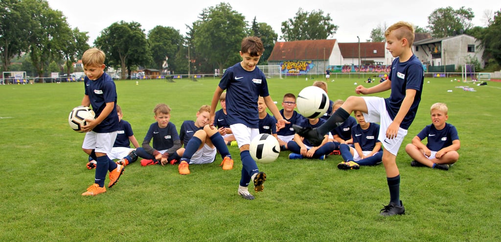 Mino, Moritz und Jonah üben im Juniorcamp beim SV Plötzkau 1921 dribbeln.