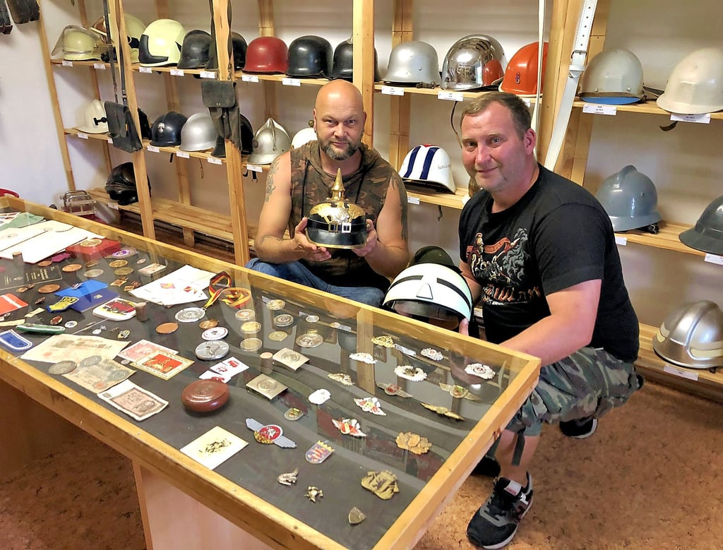 Christian Lippert (l.) und Christian Gassmann zeigen die historische Helmsammlung im Museum.