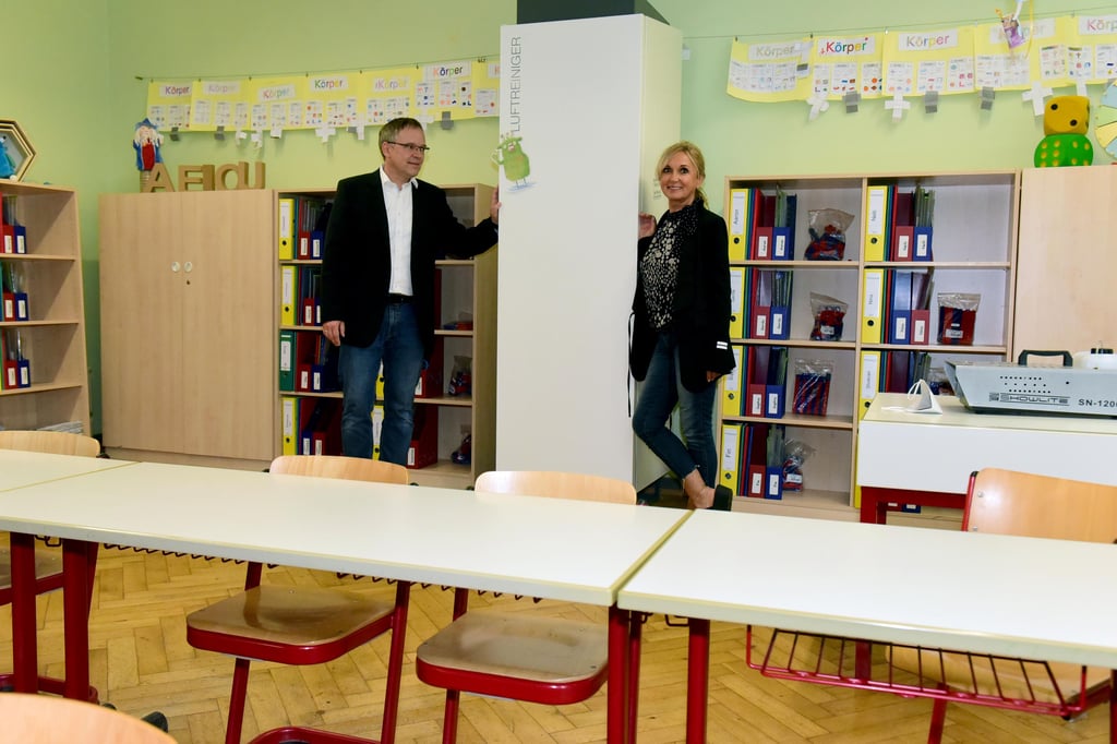 Uni-Professor Frank Beyrau und Schulleiterin Simone Tietge an einem Luftreiniger. 16 solcher Geräte werden seit März in der Magdeburger Grundschule "Am Elbdamm" getestet.