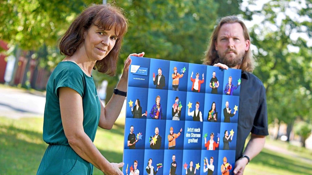 Birgit Tietz und Axel Tittel zeigen das Motiv mit den Stadt-Mitarbeitern und ihren bunten Sternen.