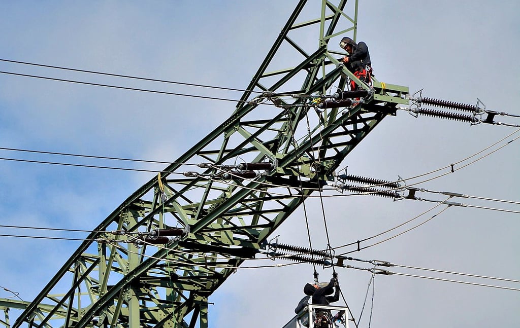 In knapp 40 Meter Höhe sind die Spezialmonteure am Umspannwerk Stendal West damit beschäftigt, die Leiterseile abzunehmen und neu anzuschließen.