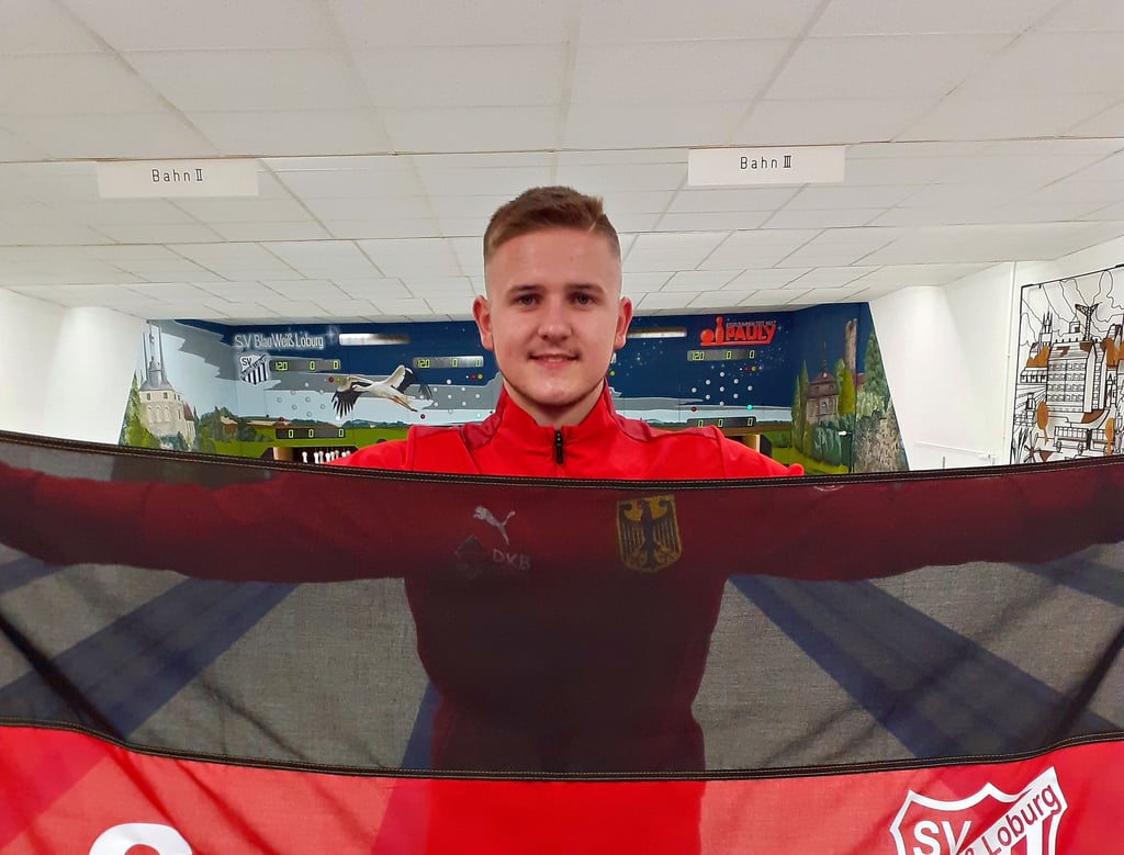 Der Loburger Jugend-Kegler Jonas Schön ist bereit für die WM in Slowenien. Sein Verein hat ihm voller Stolz eine Deutschlandfahne mit Vereinslogo überreicht und wünscht ihm damit ?Gut Holz?.