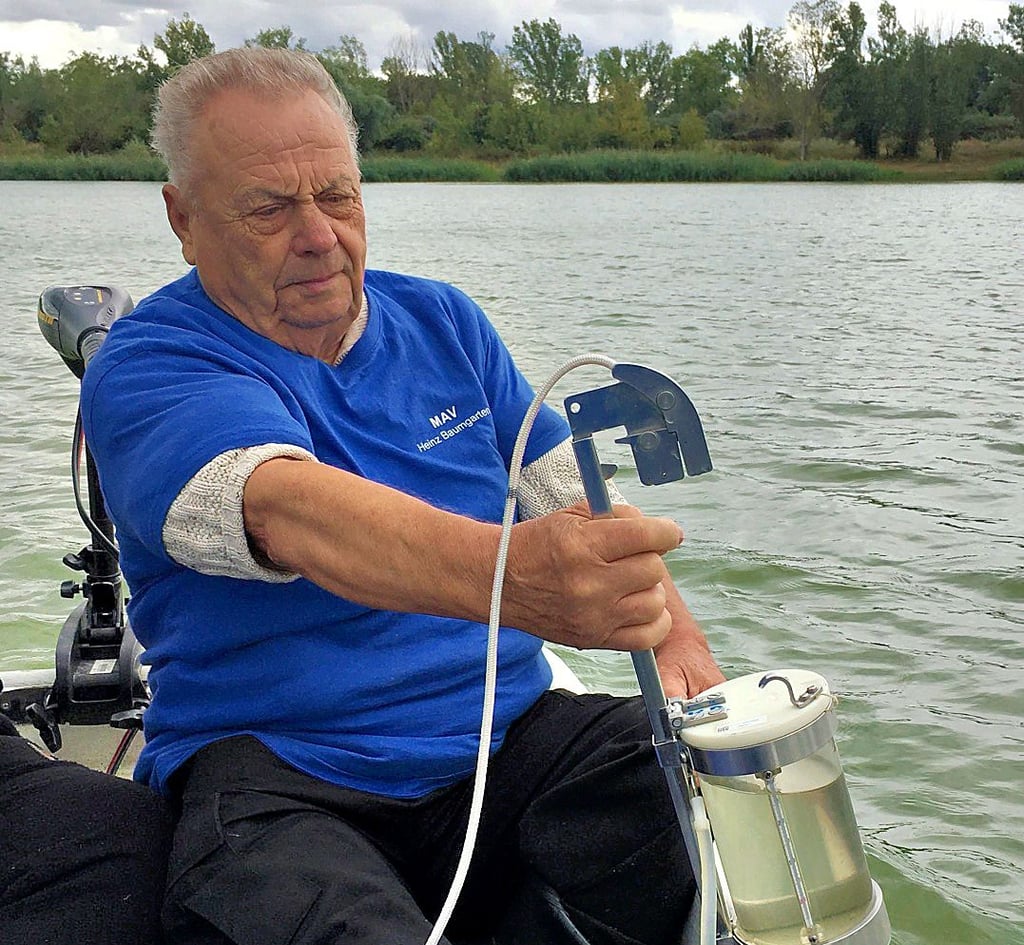 Heinz Baumgarten nimmt eine Wasserprobe im Salbker See in Magdeburg.