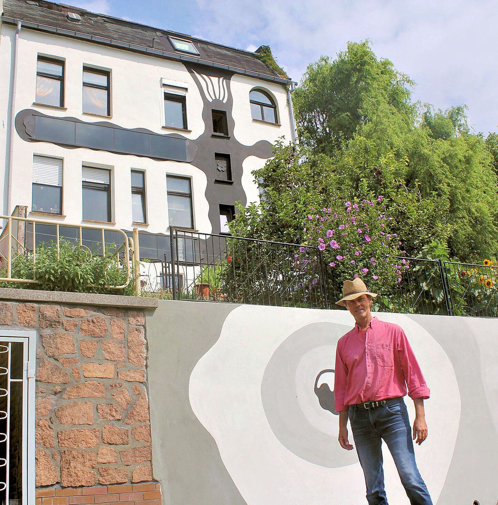 Christian Pietschiny ist stolz, dass das Mixed-Media-Kunstwerk an der Fassade eines Wohnhauses in Coswig ein Stück Nachhaltigkeit verbirgt.