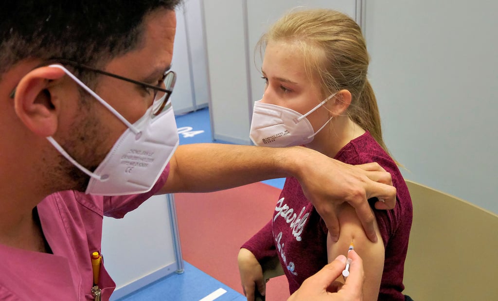 Die 14-jährige Lisa wird im Impfzentrum in Halle von Ibrahim Abu Lebdeh ein erstes Mal gegen das Coronavirus geimpft.