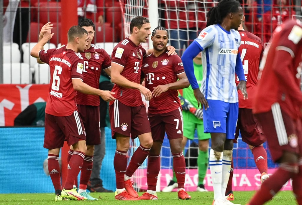 Robert Lewandowski (2.vl) trifft gegen Hertha BSC dreifach. Damit erzielte er in seinem 13. Bundesligaspiel in Serie mindestens ein Tor.