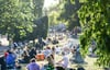 Zahlreiche Menschen sitzen im Licht der untergehenden Sonne auf einer Wiese im James-Simon-Park. Abends und nachts soll der Besuch künftig nicht mehr erlaubt sein.