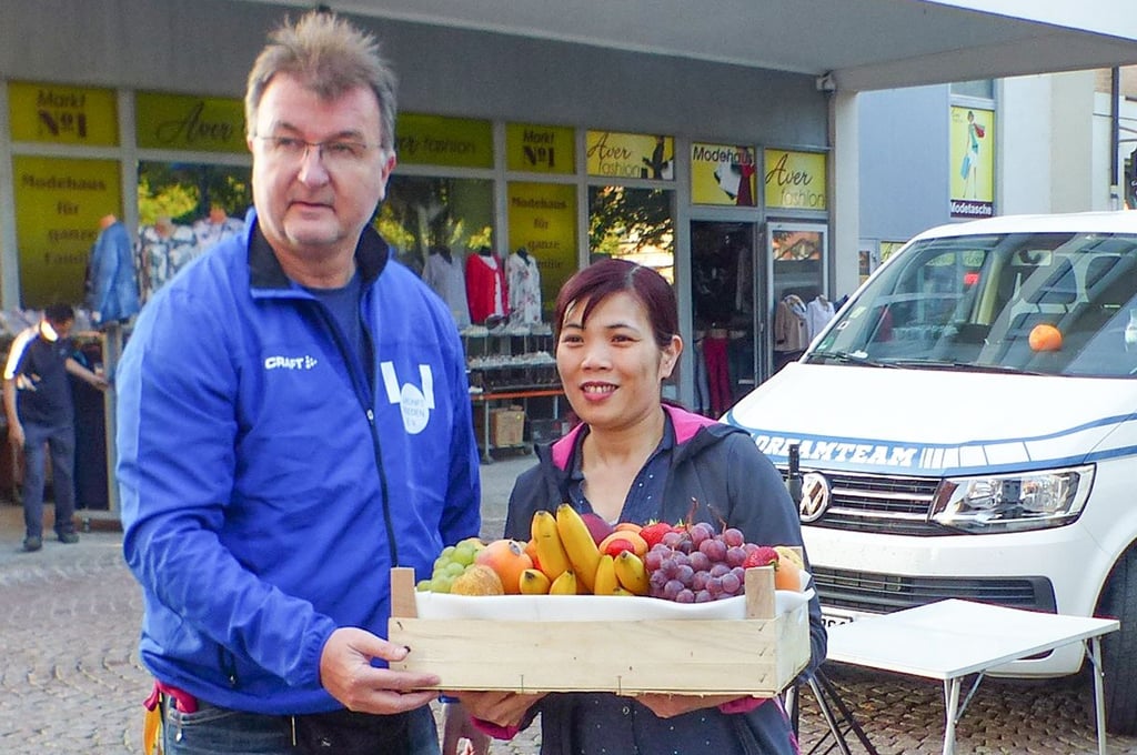 Olaf Striegan bekommt von den vietnamesischen Händlern eine Stiege Obst.