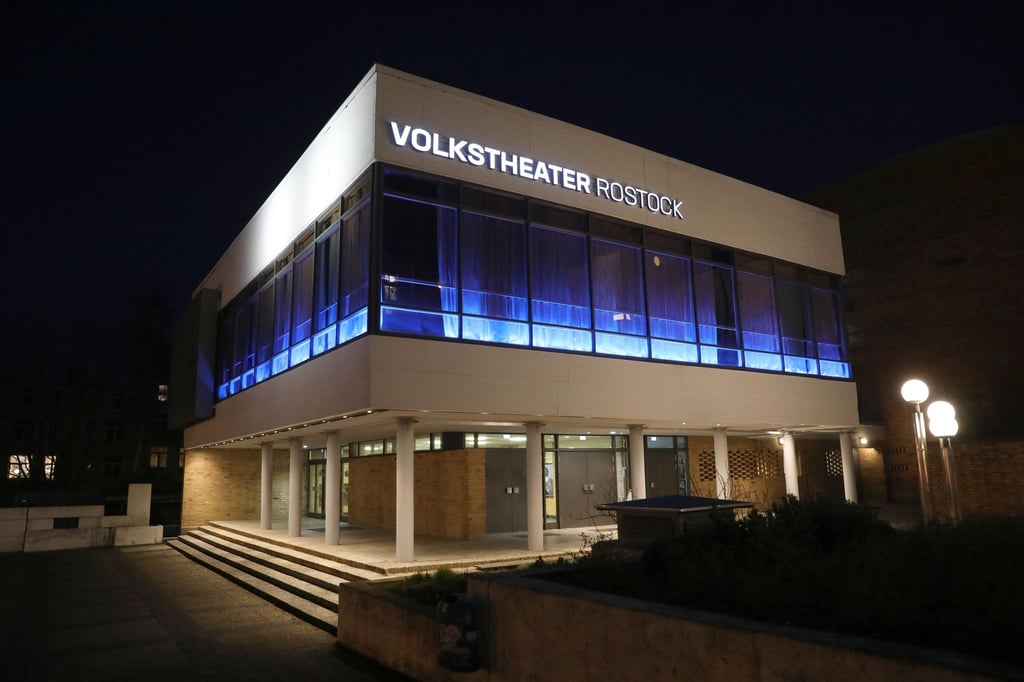 Das Volkstheater Rostock ist am Abend beleuchtet.