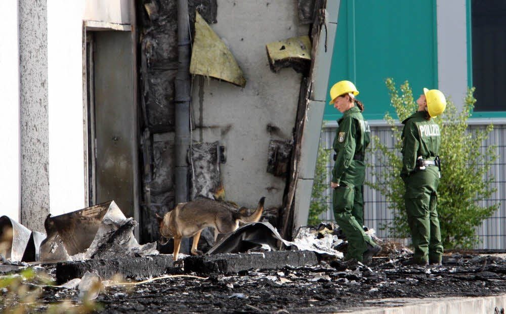 Polizei-Spürhunde suchten in der abgebrannten Turnhalle nach Spuren von Brandbeschleunigern. In der Halle sollten ab Anfang September etwa 100 Flüchtlinge vorübergehend einquartiert werden .