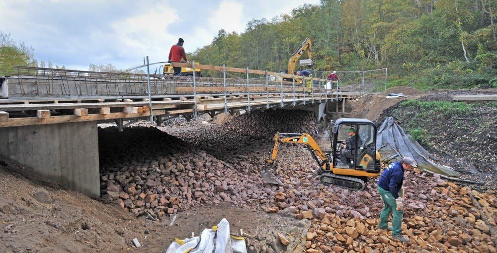Mit Wasserbausteinen wird derzeit das Flussbett profiliert (Bild oben).