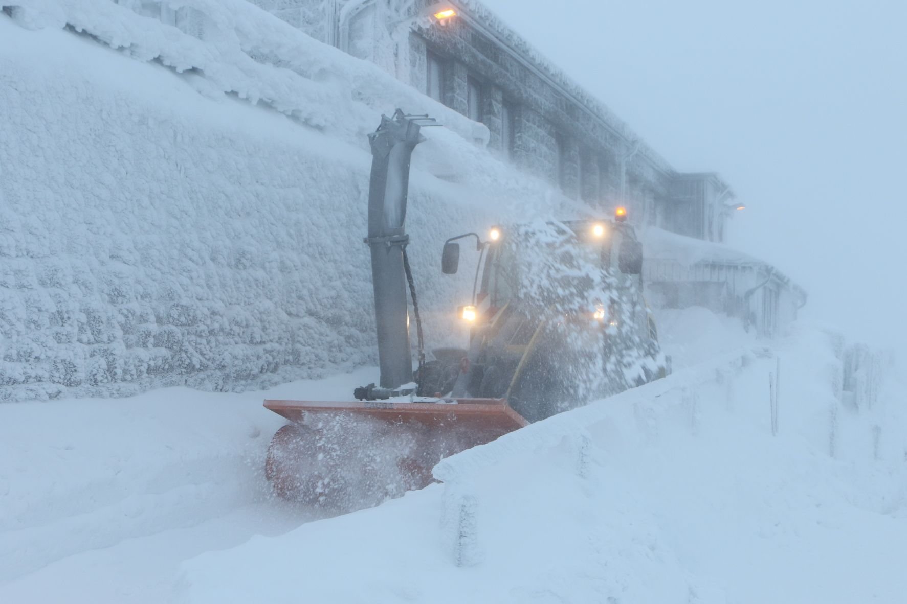 Bei eisiger Kälte räumt eine Schneefräse den Schnee von den Wegen am Brockenbahnhof.