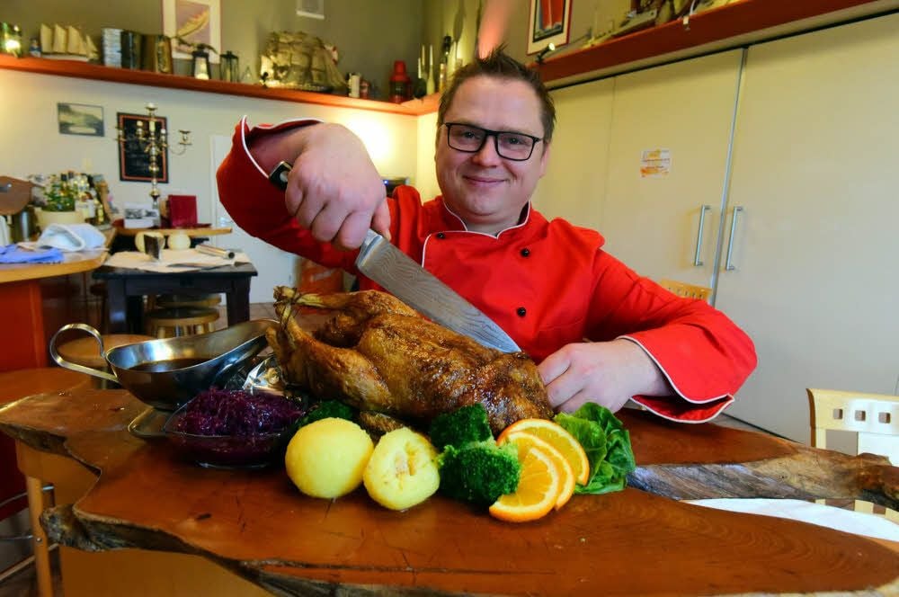 Koch Maurice Tober vom Bootshaus schneidet eine Ente an. In dem Restaurant an der Saale gibt es für die Feiertage nur noch wenige Plätze.