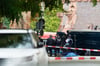 Polizisten sichern an der Mauer zum Gelände der Synagoge in Halle die Umgebung des Tatorts.