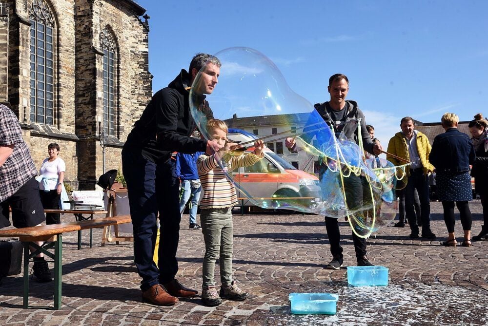 Tilo Körner von „Rondo la Kulturo“ zauberte auf dem Köthener Marktplatz mit Kindern - hier mit Lena - riesige Seifenblasen.