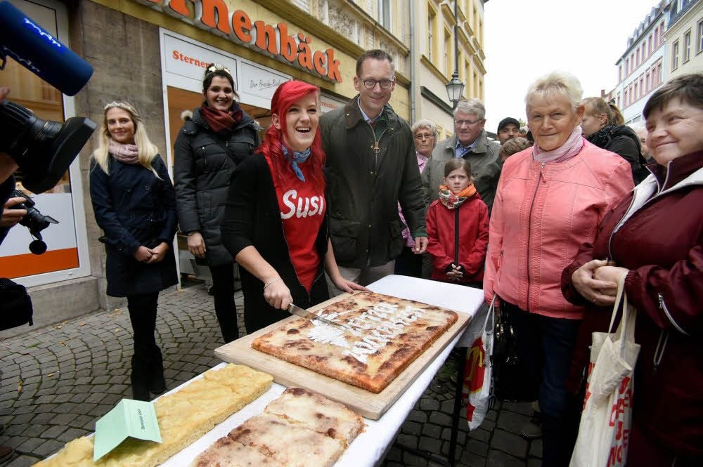 Zucker-Susi alias Anja Schulze und der Zeitzer Oberbürgermeister Christian Thieme eröffnen den Ansturm auf den Zeitzer Zuckerkuchen.