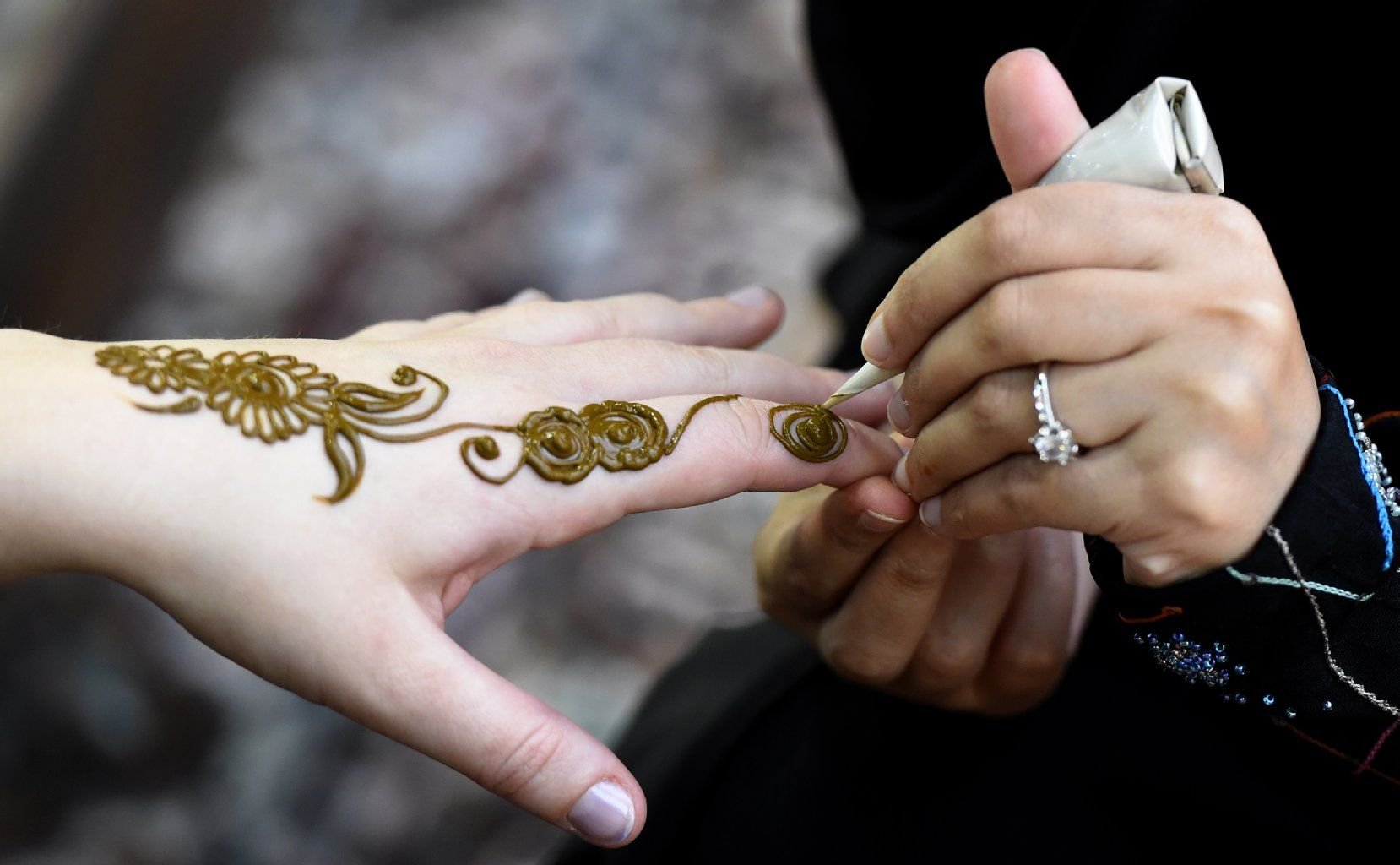 Am Ausstellungsstand von Indien können sich Besucher Henna Tattoos auf die Hand malen lassen.